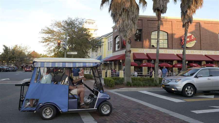 Golf cart driving through downtown streets